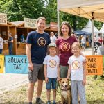 Familie beim Welt-Zöliakie-Tag Outdoor-Event mit Ständen und Besuchern